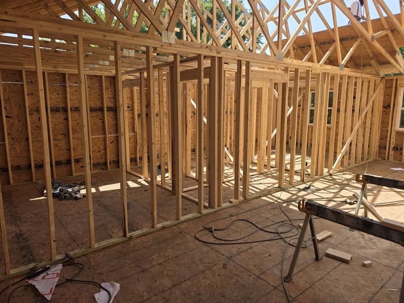 Interior stud walls and roof trusses inside a framed house