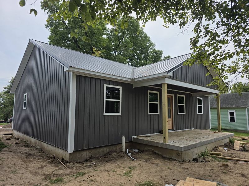 New home with metal roof and concrete front porch